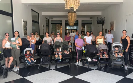 Families gathered indoors with strollers
